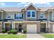 Charming townhome featuring stone accents, a one-car garage, and a welcoming front entrance at 7807 Elmshire Way, Raleigh, NC 27616