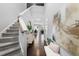 Bright foyer with hardwood floors, staircase, and stylish decor at 7807 Elmshire Way, Raleigh, NC 27616