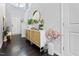 Hallway with hard wood floors leading to the front door with stylish decorations at 7807 Elmshire Way, Raleigh, NC 27616