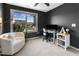Bright home office offering a seating area, modern desk and a calming view of the outdoors at 7807 Elmshire Way, Raleigh, NC 27616