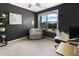 Cozy home office with natural light, a comfortable armchair and a functional desk setup at 7807 Elmshire Way, Raleigh, NC 27616