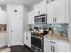 The kitchen boasts granite countertops, a stainless-steel oven, microwave, and tiled backsplash at 7807 Elmshire Way, Raleigh, NC 27616