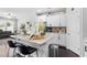 Open kitchen layout features a central island with seating, granite countertops, and stainless steel appliances at 7807 Elmshire Way, Raleigh, NC 27616