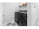 Functional laundry room featuring modern washer and dryer units against a neutral color scheme at 7807 Elmshire Way, Raleigh, NC 27616