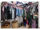 Spacious walk-in closet with ample shelving, hanging storage, and storage baskets for organization at 7807 Elmshire Way, Raleigh, NC 27616