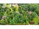 Aerial view showcasing the property's boundaries amidst lush greenery and a serene pond at 7918 Dairy Ridge Rd, Mebane, NC 27302