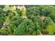 Aerial view of wooded property with lake nearby at 7918 Dairy Ridge Rd, Mebane, NC 27302