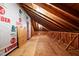 Unfinished attic space with exposed wood beams and plywood flooring at 7918 Dairy Ridge Rd, Mebane, NC 27302