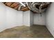 Unfinished basement with concrete walls and ceiling with exposed duct work at 7918 Dairy Ridge Rd, Mebane, NC 27302