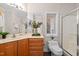 Well-lit bathroom featuring vanity, framed mirror and a glass enclosed shower at 7918 Dairy Ridge Rd, Mebane, NC 27302