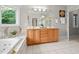 Bathroom featuring double vanities, soaking tub, and walk-in shower at 7918 Dairy Ridge Rd, Mebane, NC 27302