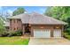 Stunning brick home showcasing a two-car garage and well-manicured landscaping at 7918 Dairy Ridge Rd, Mebane, NC 27302
