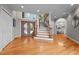 Elegant foyer showcasing hardwood floors, a staircase, and access to the dining room at 7918 Dairy Ridge Rd, Mebane, NC 27302