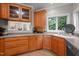 Bright kitchen featuring wood cabinetry, stainless steel appliances, and a garden view at 7918 Dairy Ridge Rd, Mebane, NC 27302