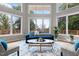 Bright living room featuring large windows, a cozy sofa, and stylish decor at 7918 Dairy Ridge Rd, Mebane, NC 27302
