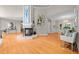 Bright living room boasts wood floors, fireplace, and an open layout to the dining area at 7918 Dairy Ridge Rd, Mebane, NC 27302