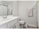 Bright bathroom featuring white vanity, white toilet, gray floor tiles, and light gray walls, with a towel rack at 805 Winter Meadow Dr, Wake Forest, NC 27587