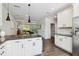Open concept kitchen shows stainless steel appliances and flows into the living area at 805 Winter Meadow Dr, Wake Forest, NC 27587