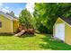 Spacious backyard with a storage shed and access to the deck, surrounded by lush trees and greenery at 8116 Owenston Ct, Raleigh, NC 27612