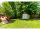 Backyard featuring a storage shed with white doors and a ramp leading to the deck area at 8116 Owenston Ct, Raleigh, NC 27612