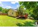 Backyard view features a wooden deck, lush green lawn, and mature shade trees at 8116 Owenston Ct, Raleigh, NC 27612