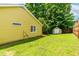 Manicured backyard featuring verdant lawn and a storage shed, blending practicality with outdoor charm at 8116 Owenston Ct, Raleigh, NC 27612