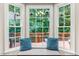 Bright dining area with a bay window overlooking a wood deck and a green yard at 8116 Owenston Ct, Raleigh, NC 27612
