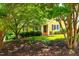 Charming yellow home with trees and shrubbery in a peaceful neighborhood at 8116 Owenston Ct, Raleigh, NC 27612