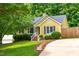 Inviting yellow home with well-maintained lawn and attractive landscaping at 8116 Owenston Ct, Raleigh, NC 27612