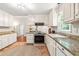 Spacious kitchen featuring granite countertops, white cabinets, and stainless steel appliances at 8116 Owenston Ct, Raleigh, NC 27612