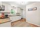 Functional kitchen with granite countertops, white cabinets and modern appliances at 8116 Owenston Ct, Raleigh, NC 27612