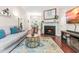Inviting living room with a cozy fireplace and open view to the dining room at 8116 Owenston Ct, Raleigh, NC 27612