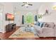 Bright and spacious living room, featuring large window and hardwood flooring at 8116 Owenston Ct, Raleigh, NC 27612