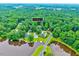 Property nestled among lush trees, near lake access, and other homes at 819 & 818 Hilltop Cir, Sanford, NC 27332