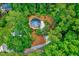 Unique round home surrounded by lush trees offering privacy and seclusion at 819 & 818 Hilltop Cir, Sanford, NC 27332