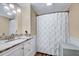 Bathroom featuring granite vanity, brushed nickel faucet, and shower with decorative curtain at 819 & 818 Hilltop Cir, Sanford, NC 27332