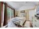 Cozy bedroom with a bed, bench, dresser, and a sliding door to a private deck at 819 & 818 Hilltop Cir, Sanford, NC 27332