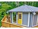 Unique home with a yellow entry door and a spacious wraparound deck at 819 & 818 Hilltop Cir, Sanford, NC 27332
