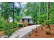 Charming lake house exterior surrounded by trees and featuring a paved driveway and wooden deck with lake views at 819 & 818 Hilltop Cir, Sanford, NC 27332