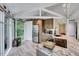 Open kitchen with granite countertops, stainless steel appliances, and bright light from adjacent windows and door at 819 & 818 Hilltop Cir, Sanford, NC 27332