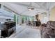 Bright living room with vaulted ceilings, ceiling fan, kitchen bar, plush furniture, and views of the outdoors at 819 & 818 Hilltop Cir, Sanford, NC 27332