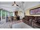 Inviting living room featuring vaulted ceilings, a kitchen bar, plush seating, and natural light from surrounding windows at 819 & 818 Hilltop Cir, Sanford, NC 27332