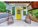 Outdoor living space with seating, a yellow door with wreath, and wooded views at 819 & 818 Hilltop Cir, Sanford, NC 27332
