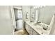 Bathroom with double sink vanity, marble countertops, decorative towels, and view to another room at 923 Springfork Dr, Cary, NC 27513