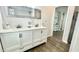 Bathroom featuring a double sink vanity, storage cabinets and view into another room at 923 Springfork Dr, Cary, NC 27513