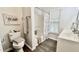 Bathroom featuring a toilet, combination tub and shower, sink and decorative towels and accessories at 923 Springfork Dr, Cary, NC 27513