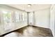 Bedroom features wood floors, glass door to balcony, window, and closet at 923 Springfork Dr, Cary, NC 27513