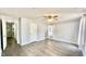 A spacious bedroom with hardwood floors, a ceiling fan, and large windows providing natural light at 923 Springfork Dr, Cary, NC 27513