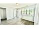 Bedroom with wood floors, glass doors to a balcony, and large windows providing lots of natural light at 923 Springfork Dr, Cary, NC 27513