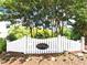 A charming entrance to Cedar Pointe with a white fence and beautiful landscaping at 923 Springfork Dr, Cary, NC 27513